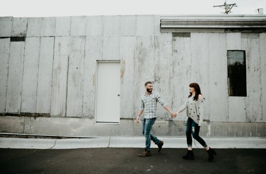 engaged couple walking together laughing