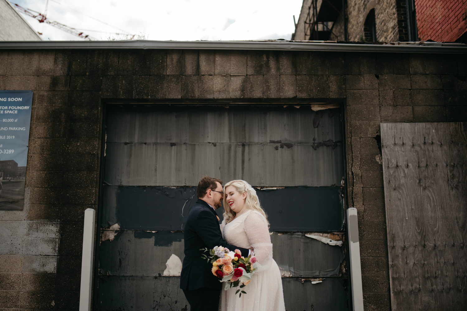 Bride and Groom posing in an industrial doorway in Minneapolis