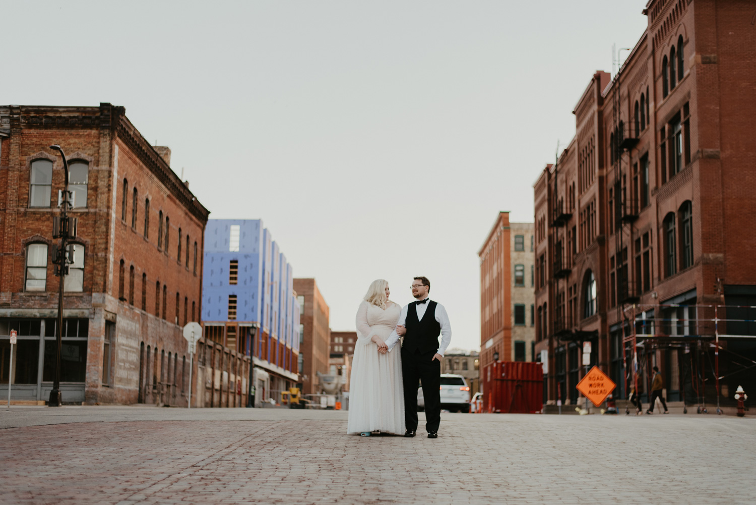 Bride and groom twirling in the middle of Minneapolis street during sunset