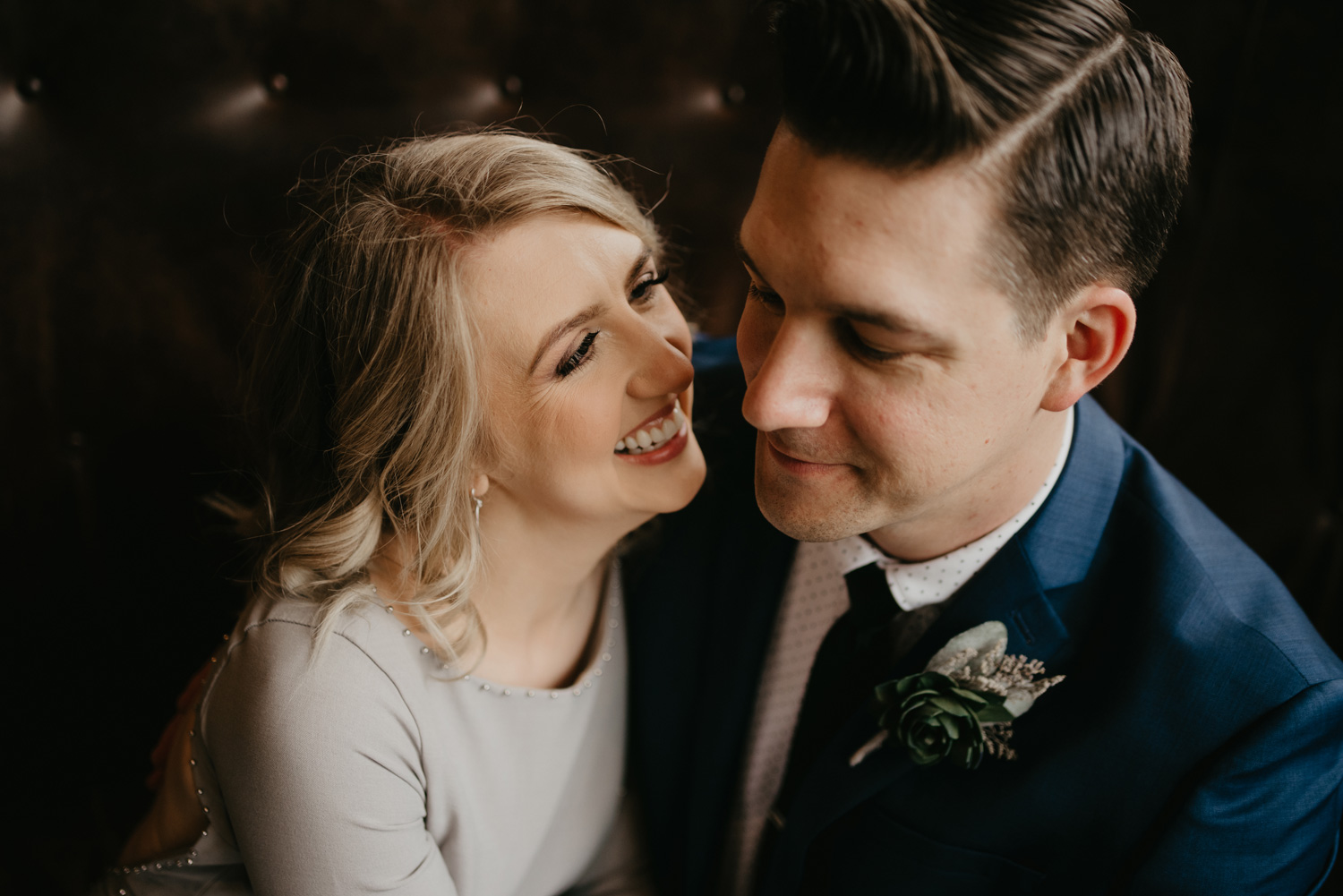 Bride and groom cuddling indoors on couch Hewing Hotel Minneapolis