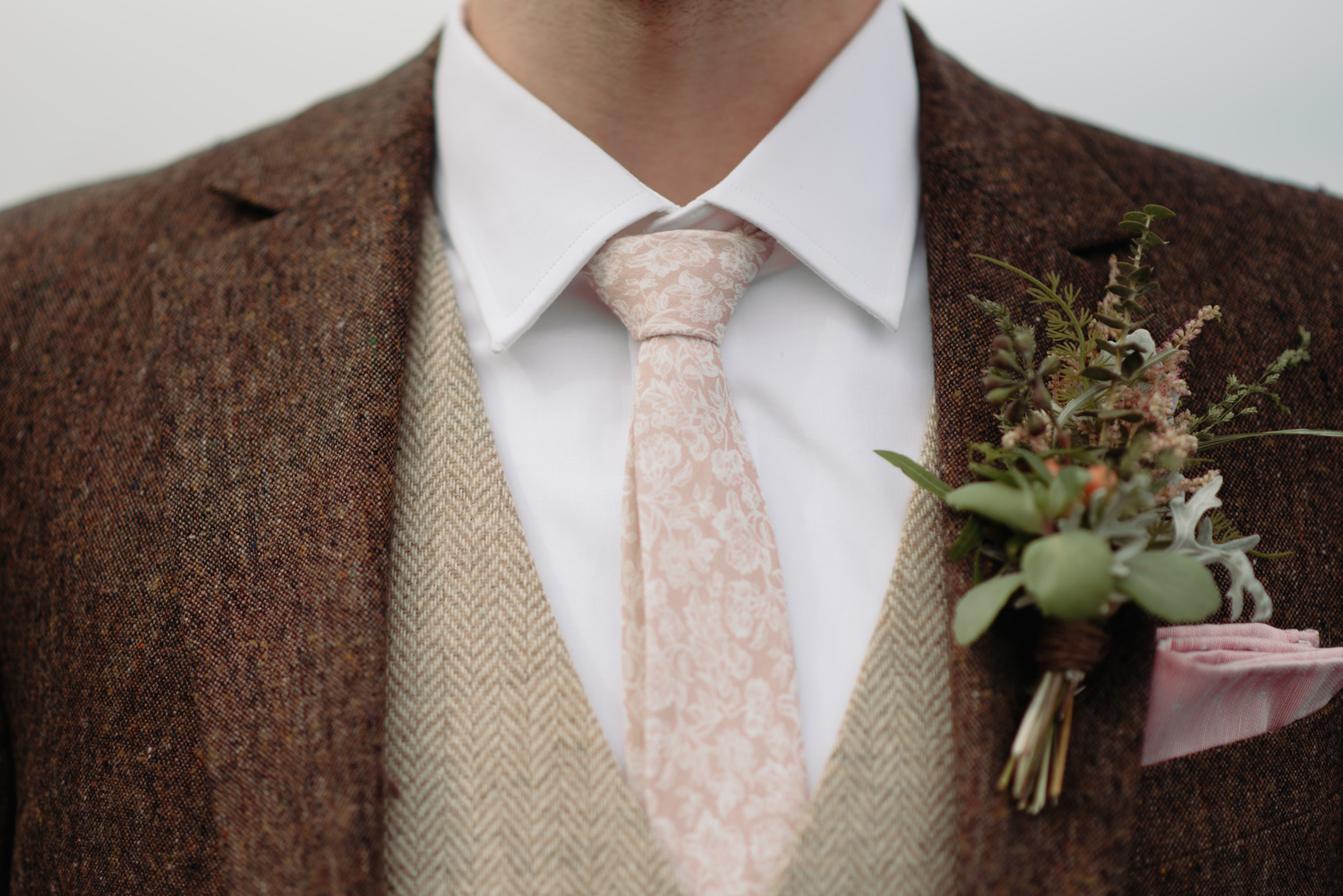 groom tweed custom suit and pink floral tie