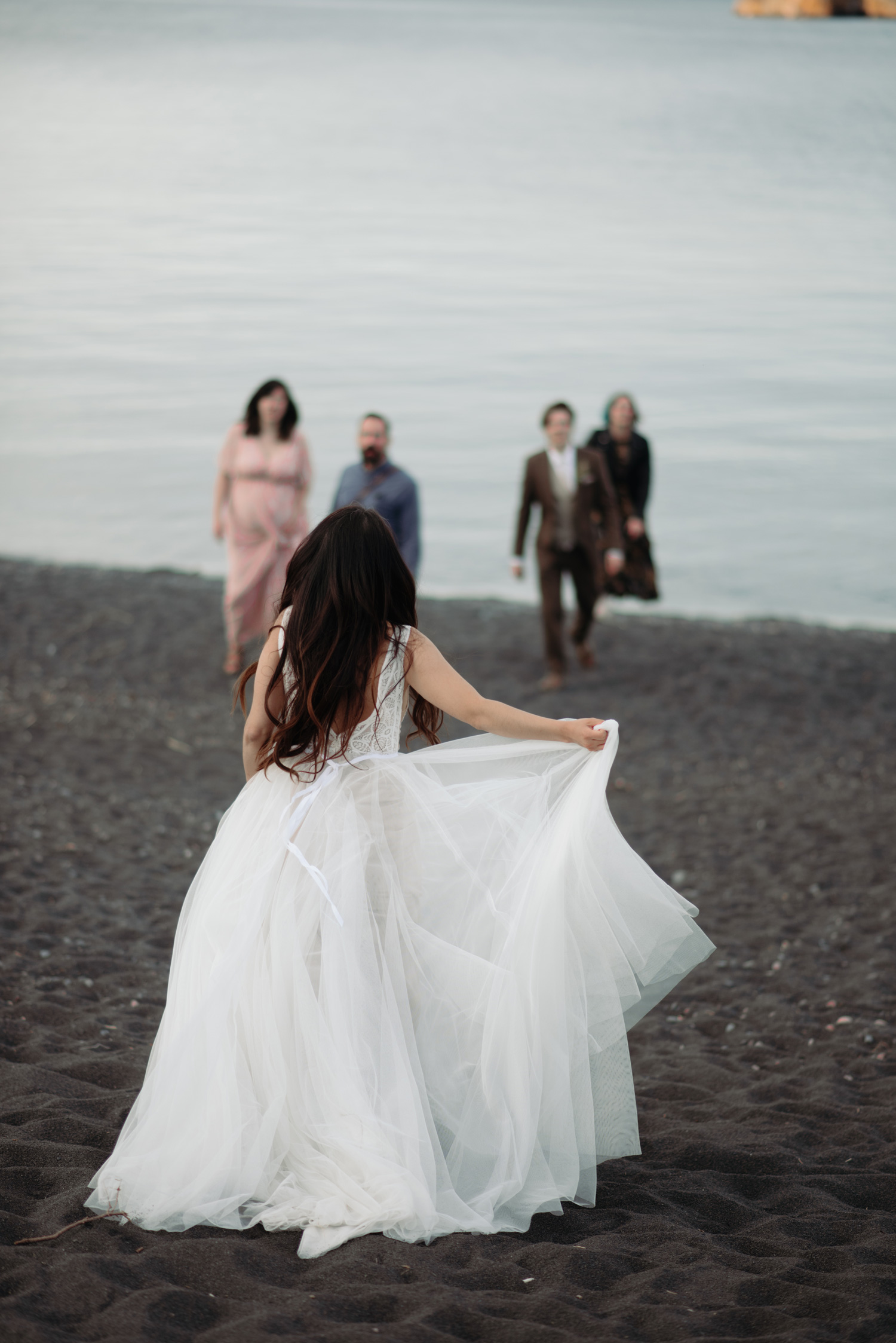 bride running towards friends minnesota north shore elopement