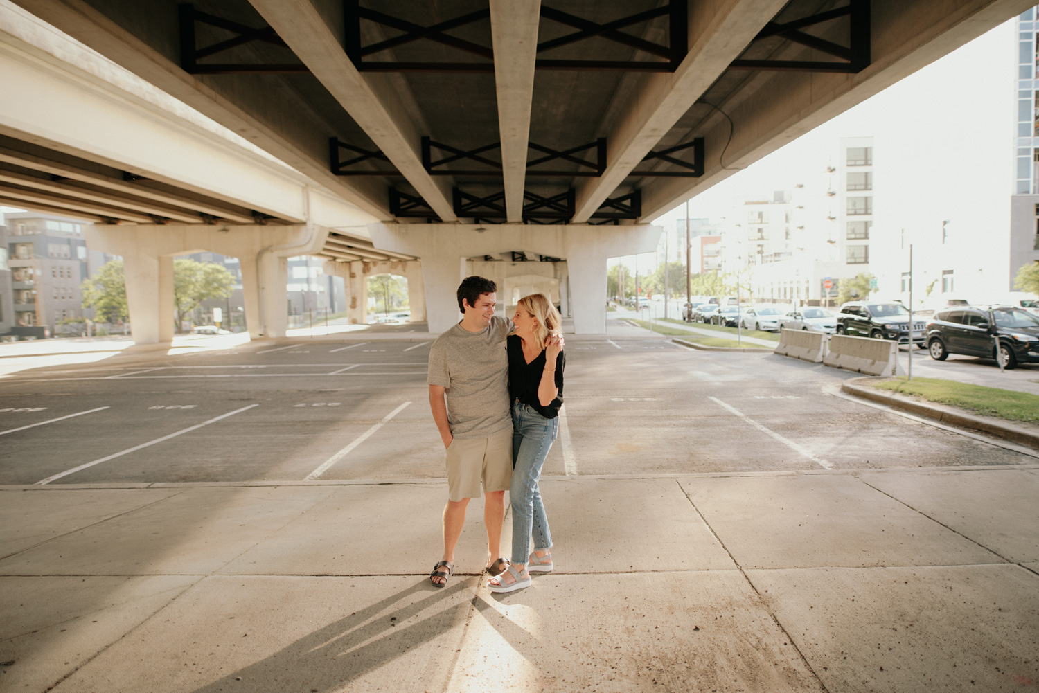 engaged couple walking under bridge underpass minneapolis