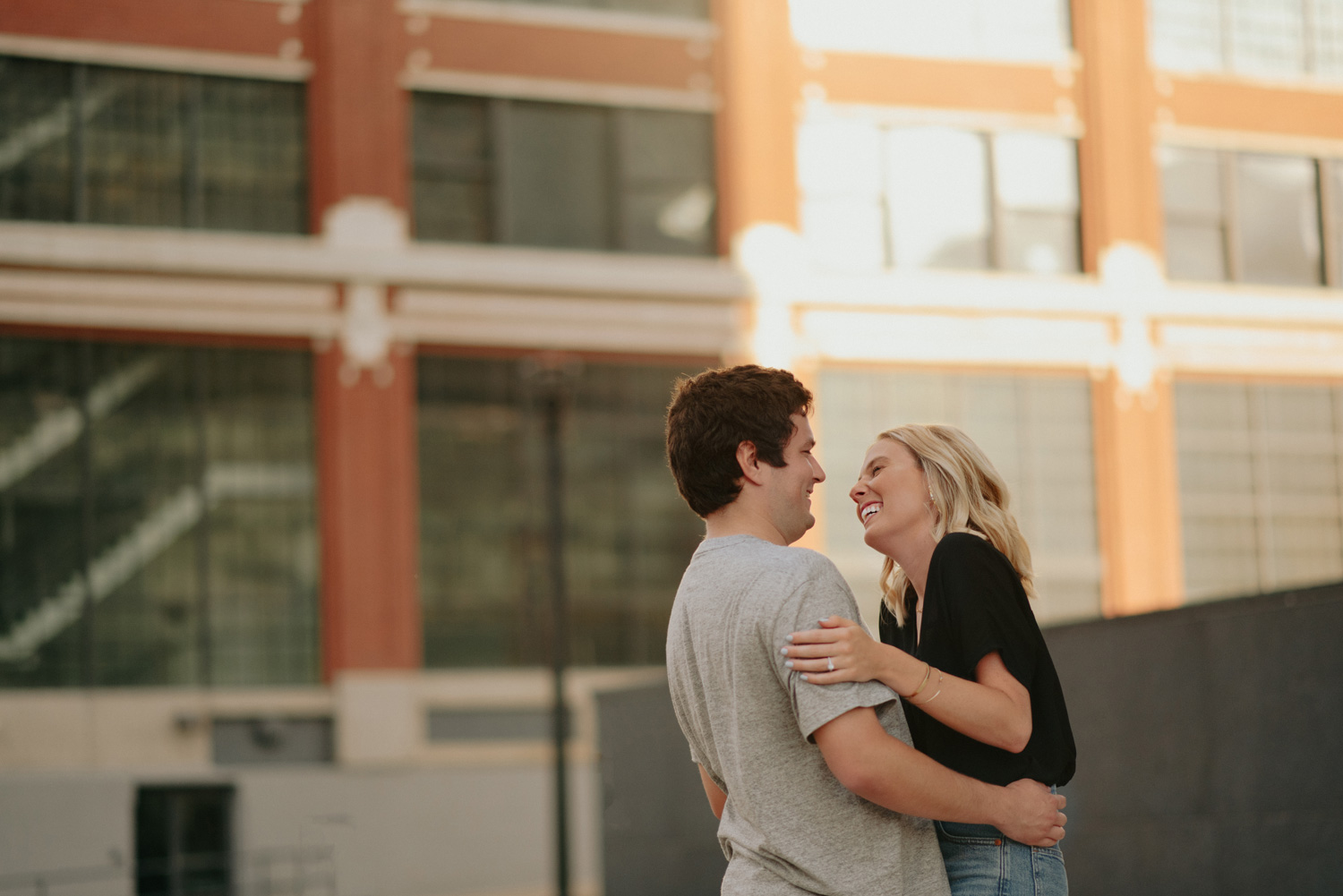 couple in front of glass warehouse building north loop minneapolis