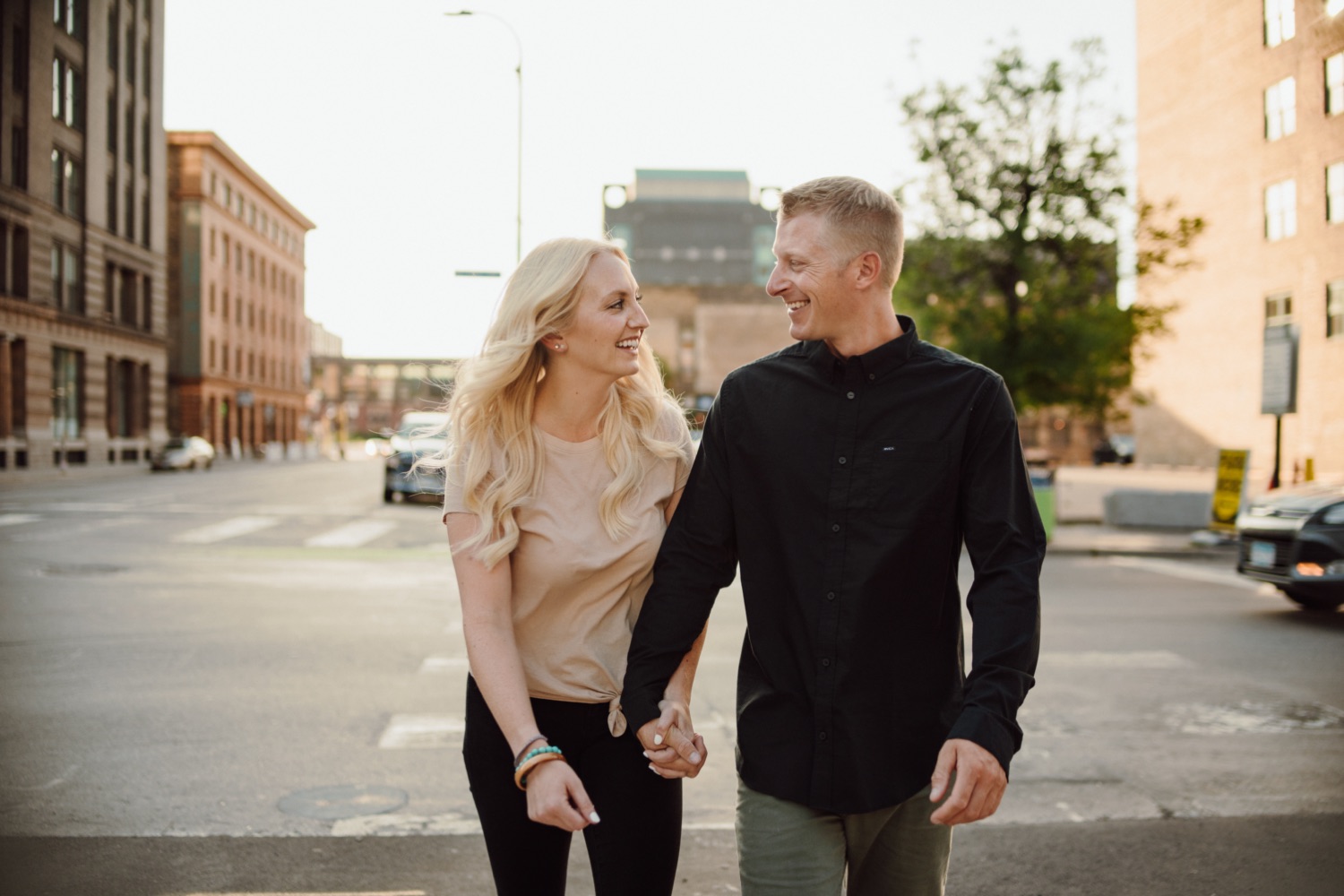 engaged couple walking in downtown Minneapolis
