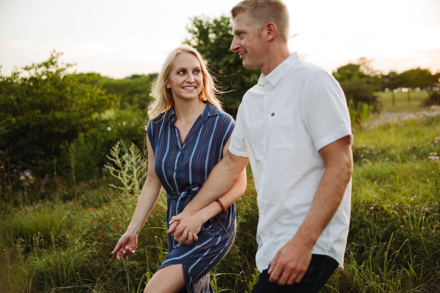 Engaged couple in summer field minneapolis photo session