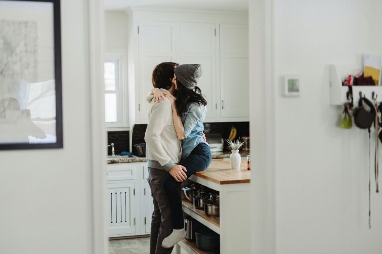 couple cuddling in the kitchen intimate in home session