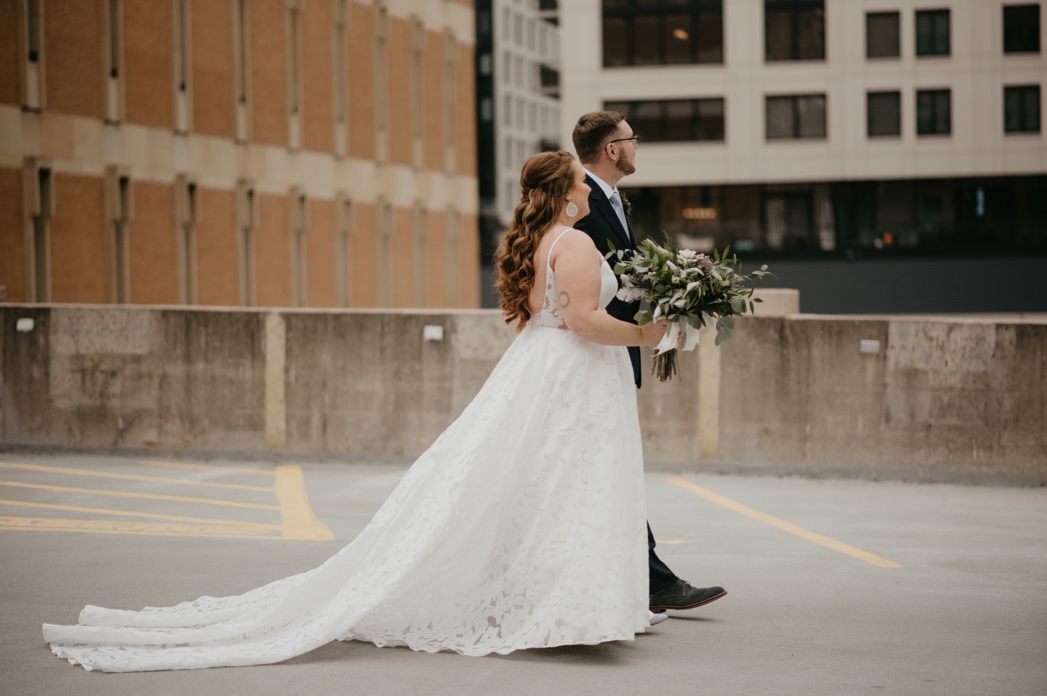 bride and groom walking together parking garage rooftop lumber exchange mpls