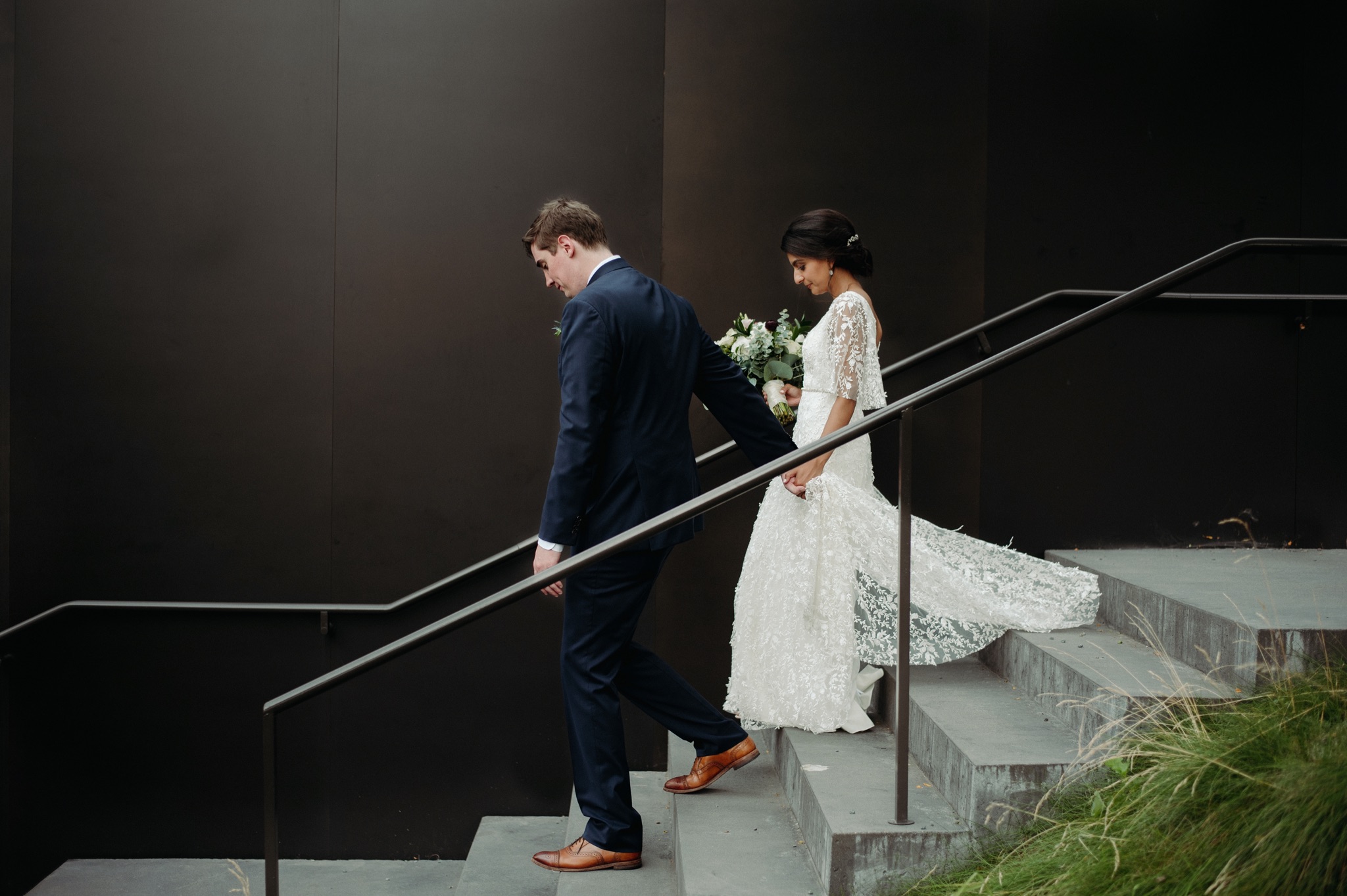 bride and groom walking down stairs, black background walker art center wedding